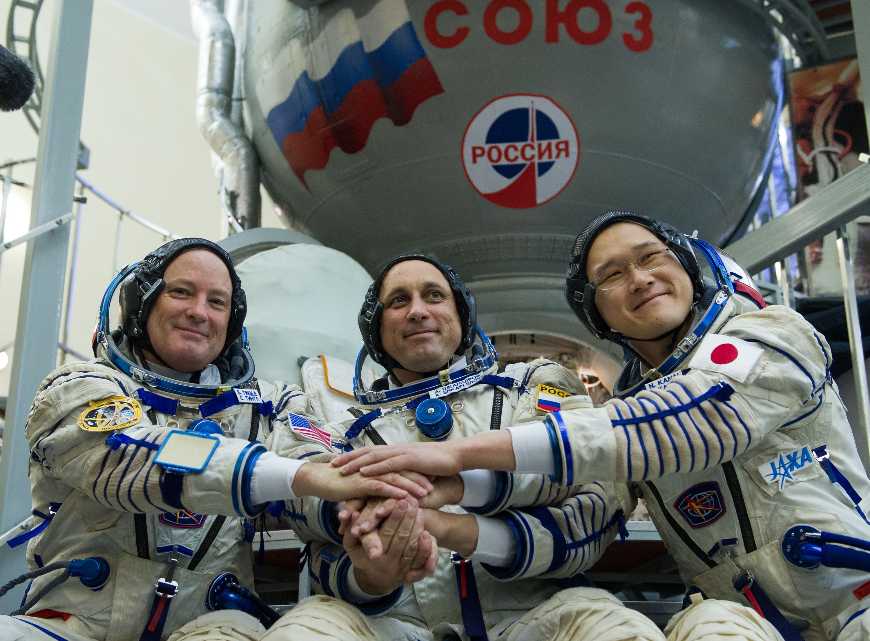 Members of the International Space Station (ISS) expedition 54/55, NASA astronaut Scott Tingle (L), Roscosmos cosmonaut Anton Shkaplerov (C) and Norishige Kanai of the Japan Aerospace Exploration Agency (JAXA) shake hands before their final exam at the Gagarin Cosmonauts' Training Centre in Star City outside Moscow on November 29, 2017. (STR/AFP/Getty Images)