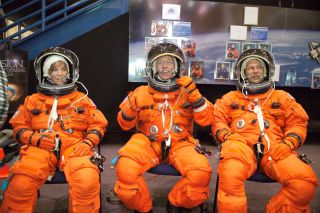 Astronauts Lisa M. Nowak, Michael E. Fossum and Piers J. Sellers wear training versions of the shuttle launch-and-entry spacesuit.