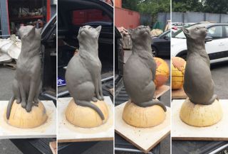 A clay model of the Félicette statue. The final product will feature the cat sitting on top of a globe of the Earth.