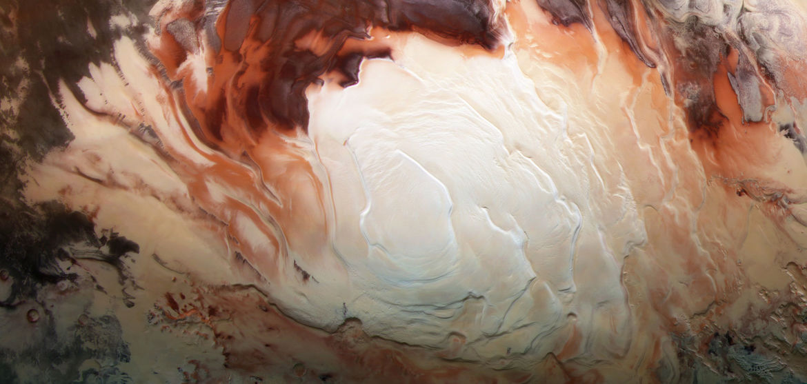 The southern polar ice cap of Mars (using infrared, green, and blue light), which is mostly water ice with a thin layer of carbon dioxide ice on top, taken by Mars Express. Credit: ESA / G. Neukum (Freie Universitaet, Berlin) / Bill Dunford