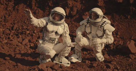 Astronauts collecting rock samples on Mars