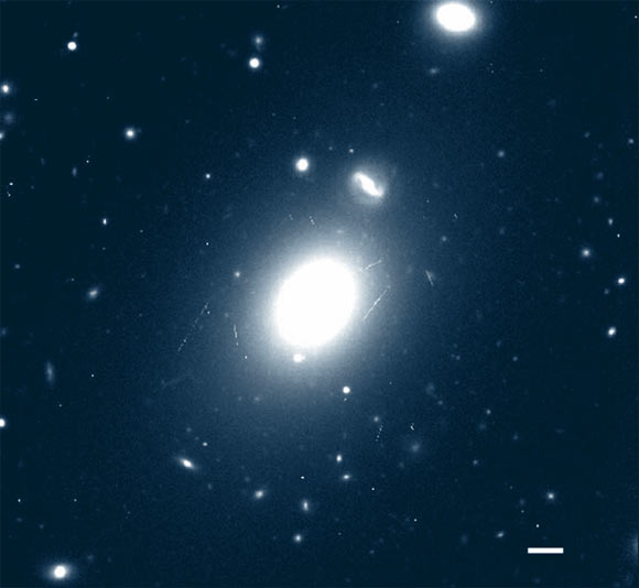 Gemini Multi Object Spectrograph image of the Holmberg 15A (center). Discovered in the 1930s by astronomer Erik Holmberg, this galaxy is located about 700 million light-years away in the constellation Cetus. Holmberg 15A’s central black hole is estimated to have a mass of 40 billion suns. By comparison, the mass of the supermassive black hole found at the center of our Milky Way Galaxy is only about 4 million suns. Scale bar - 10 kpc (32,616 light-years). Image credit: Juan P. Madrid & Carlos J. Donzelli, doi: 10.3847/0004-637X/819/1/50.