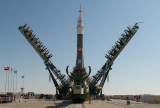 The arms of a mobile gantry close around the Soyuz rocket that will launch three Expedition 61 crewmembers to the International Space Station, shortly after the rocket was erected on the pad at the Baikonur Cosmodrome in Kazakhstan. On Wednesday (Sept. 25), this rocket will launch the Soyuz MS-15 spacecraft with NASA astronaut Jessica Meir, Russian cosmonaut Oleg Skripochka and Hazza Ali Almansouri, the first astronaut of the United Arab Emirates.