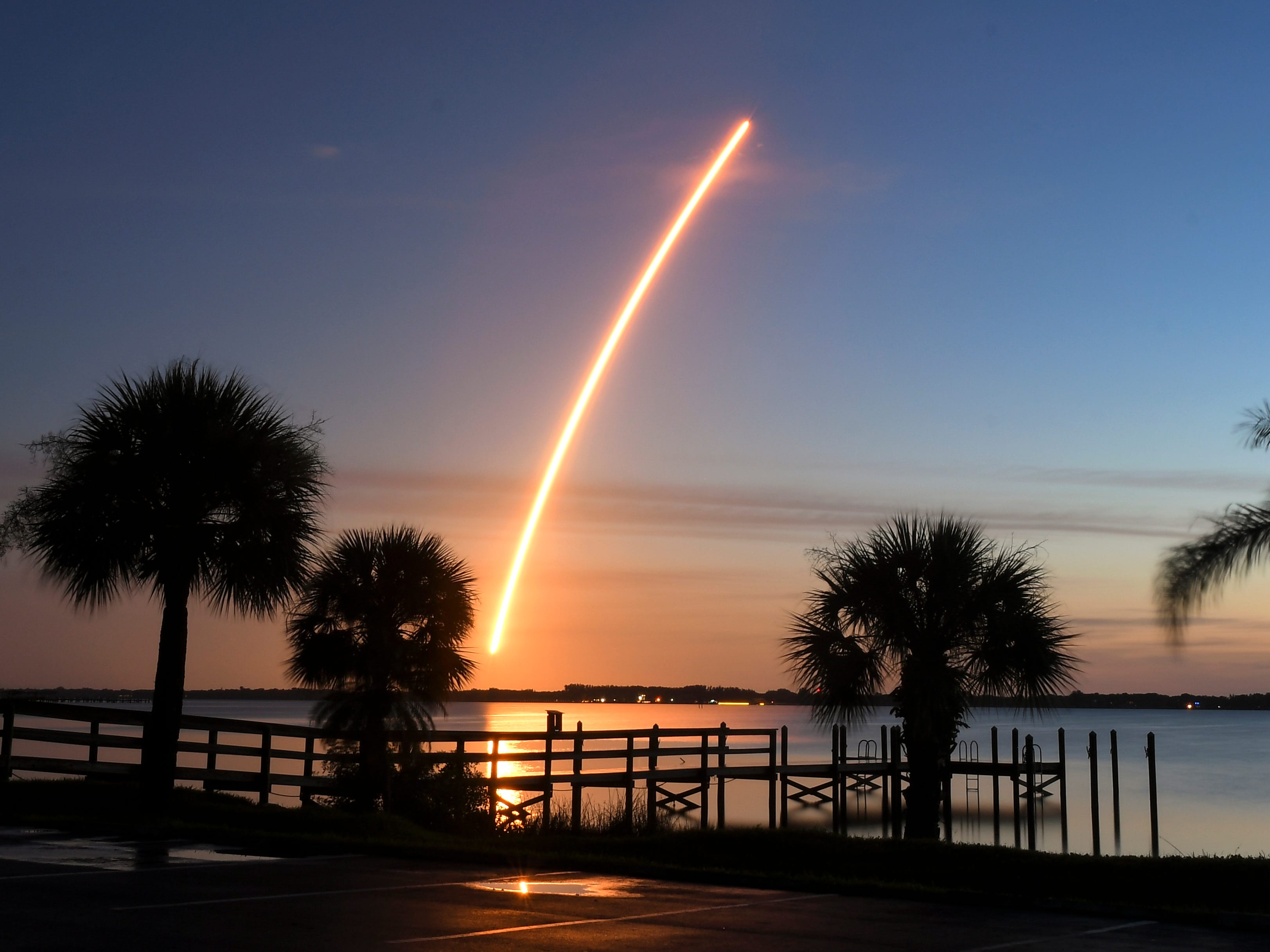 A United Launch Alliance Atlas V rocket lifts off from Cape Canaveral Air Force Station Aug. 8, 2019 carrying the AEHF 5 communications satellite for the U.S. military. This photo was made in the parking lot of River Rocks restaurant along the Indian River in Rockledge, Fla. 