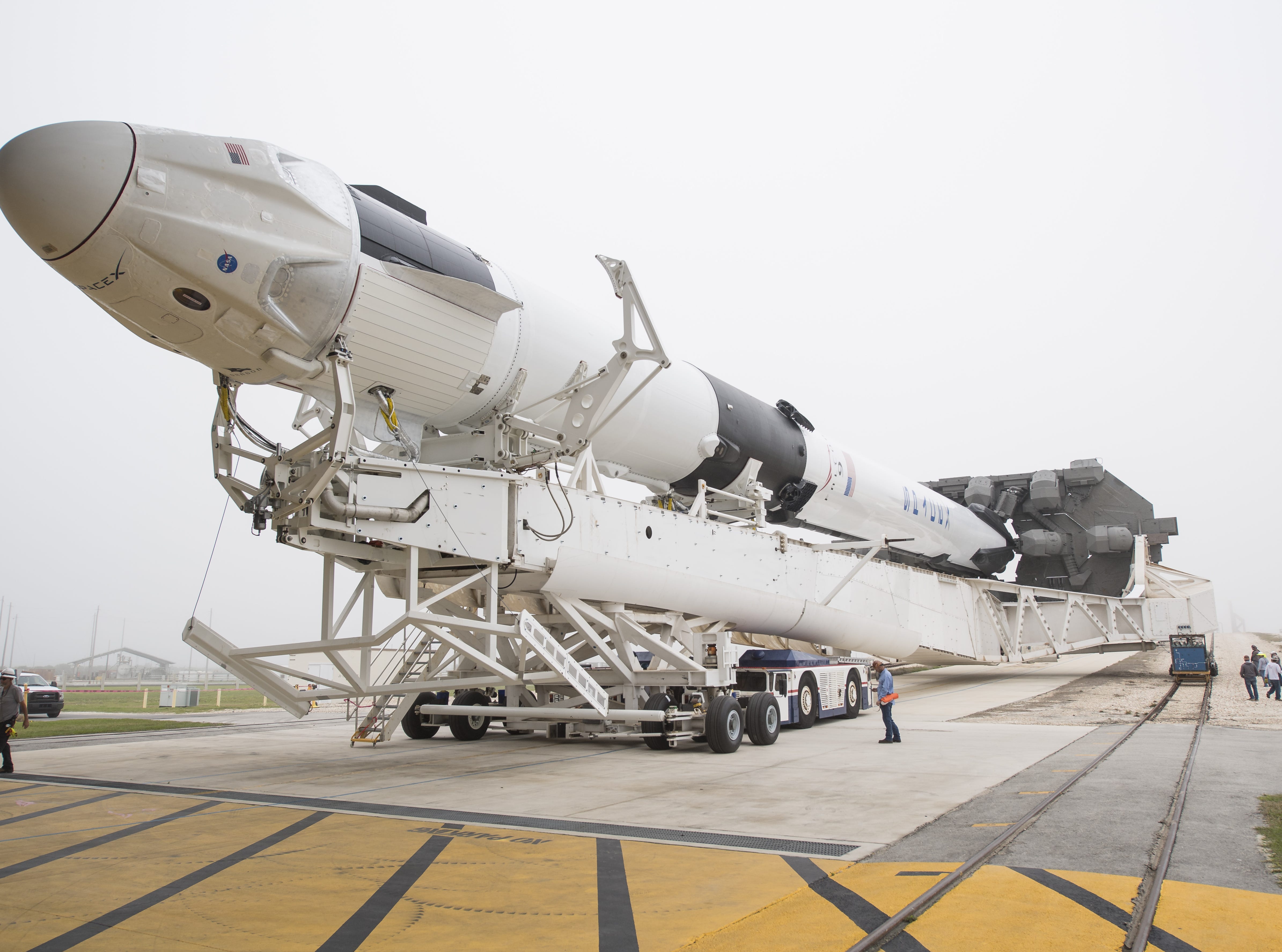 A SpaceX Falcon 9 rocket with the company's Crew Dragon spacecraft onboard as it is rolled out of the horizontal integration facility at Launch Complex 39A Feb. 28, 2019 at the Kennedy Space Center in Fla. 