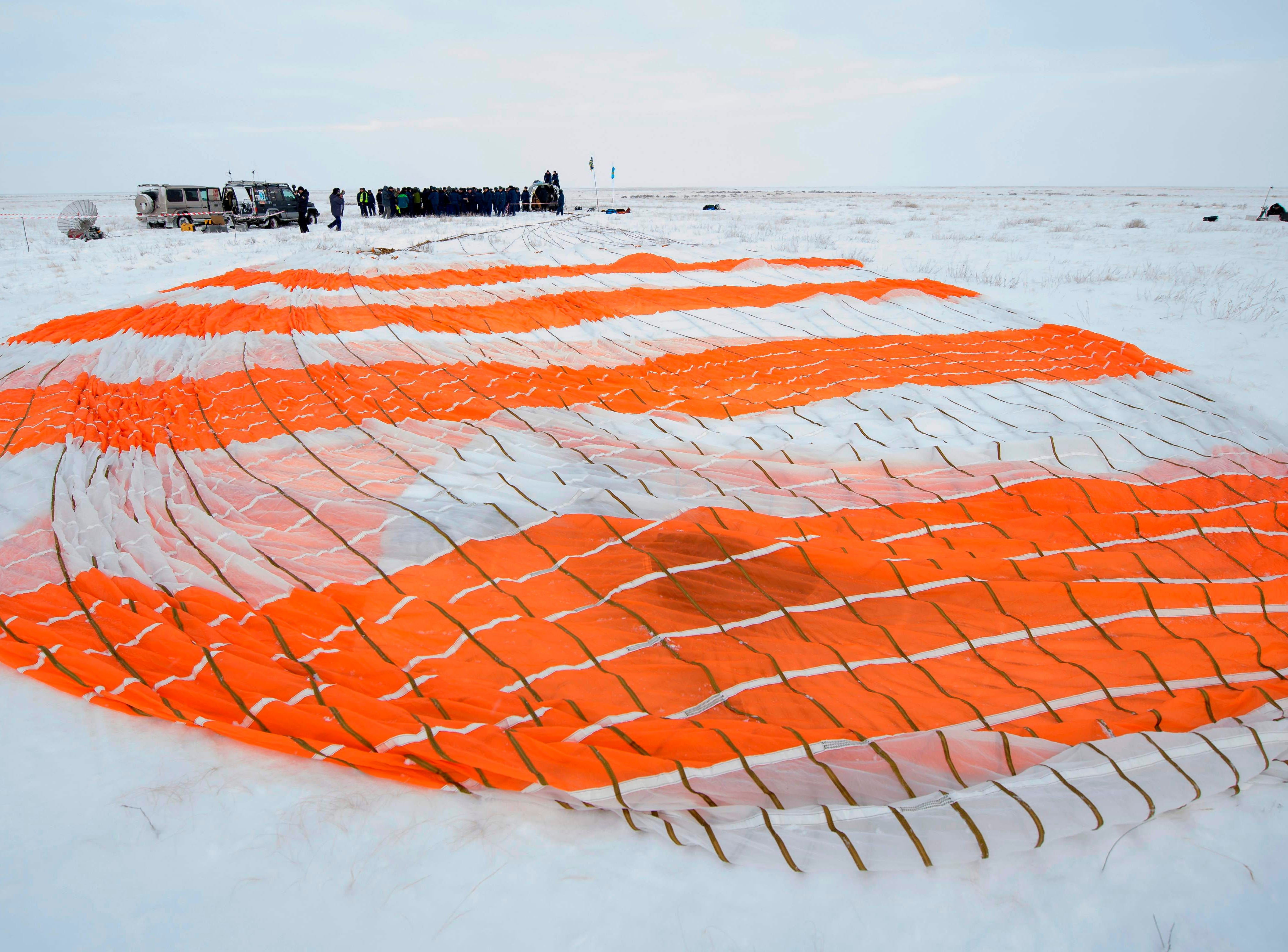 The parachute of the Soyuz MS-09 spacecraft lies in the snow shortly after the capsule landed with Expedition 57 crew members in a remote area outside the town of Dzhezkazgan Kazakhstan, Dec. 20, 2018. 