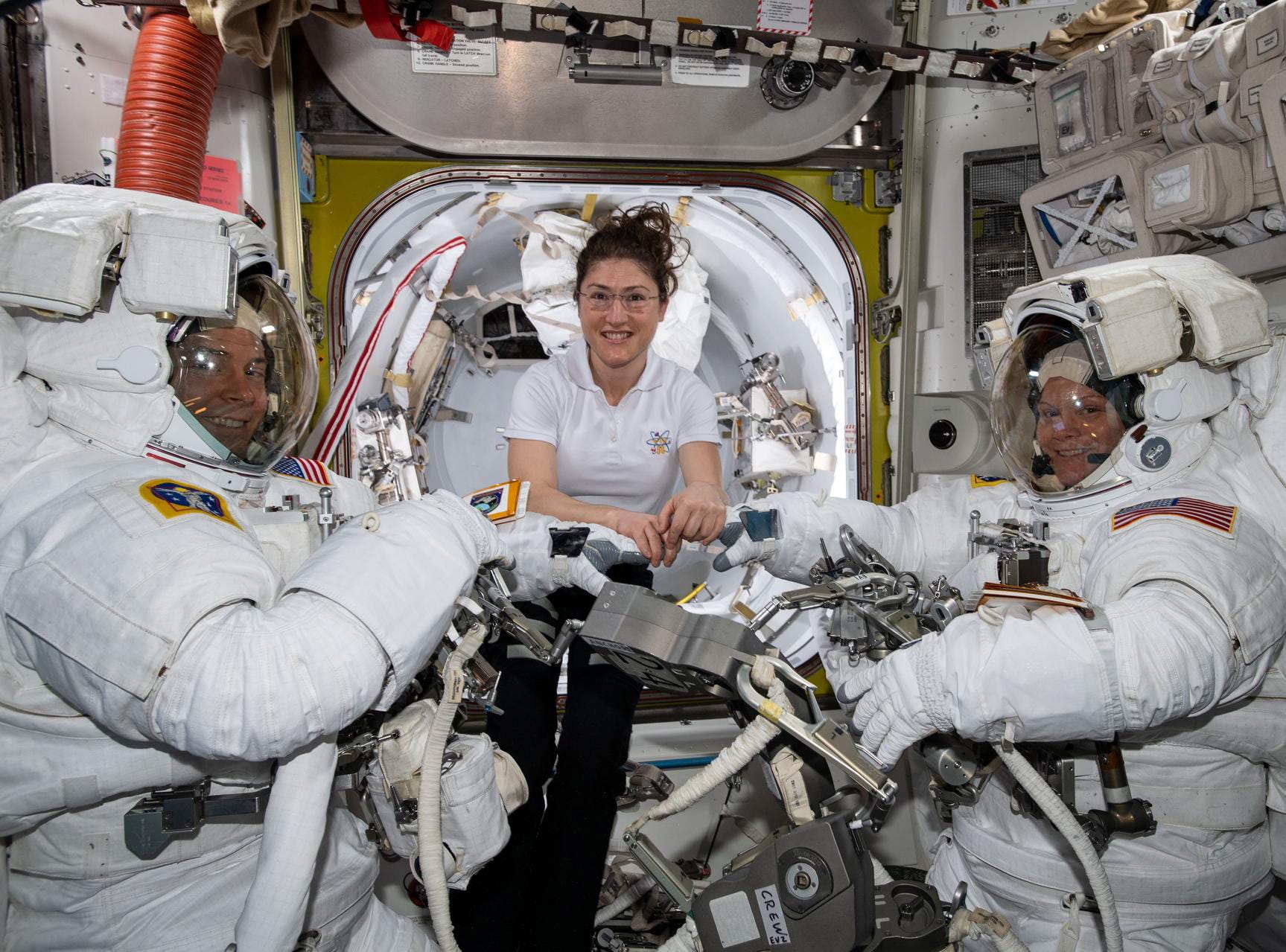 NASA astronaut Christina Koch assists fellow astronauts Nick Hague and Anne McClain in their spacesuits shortly before they begin the first spacewalk of their careers, aboard the International Space Station (ISS), March, 22, 2019 NASA cancelled the first all-female spacewalk which was scheduled for March 29, 2019, citing spacesuit issues. 