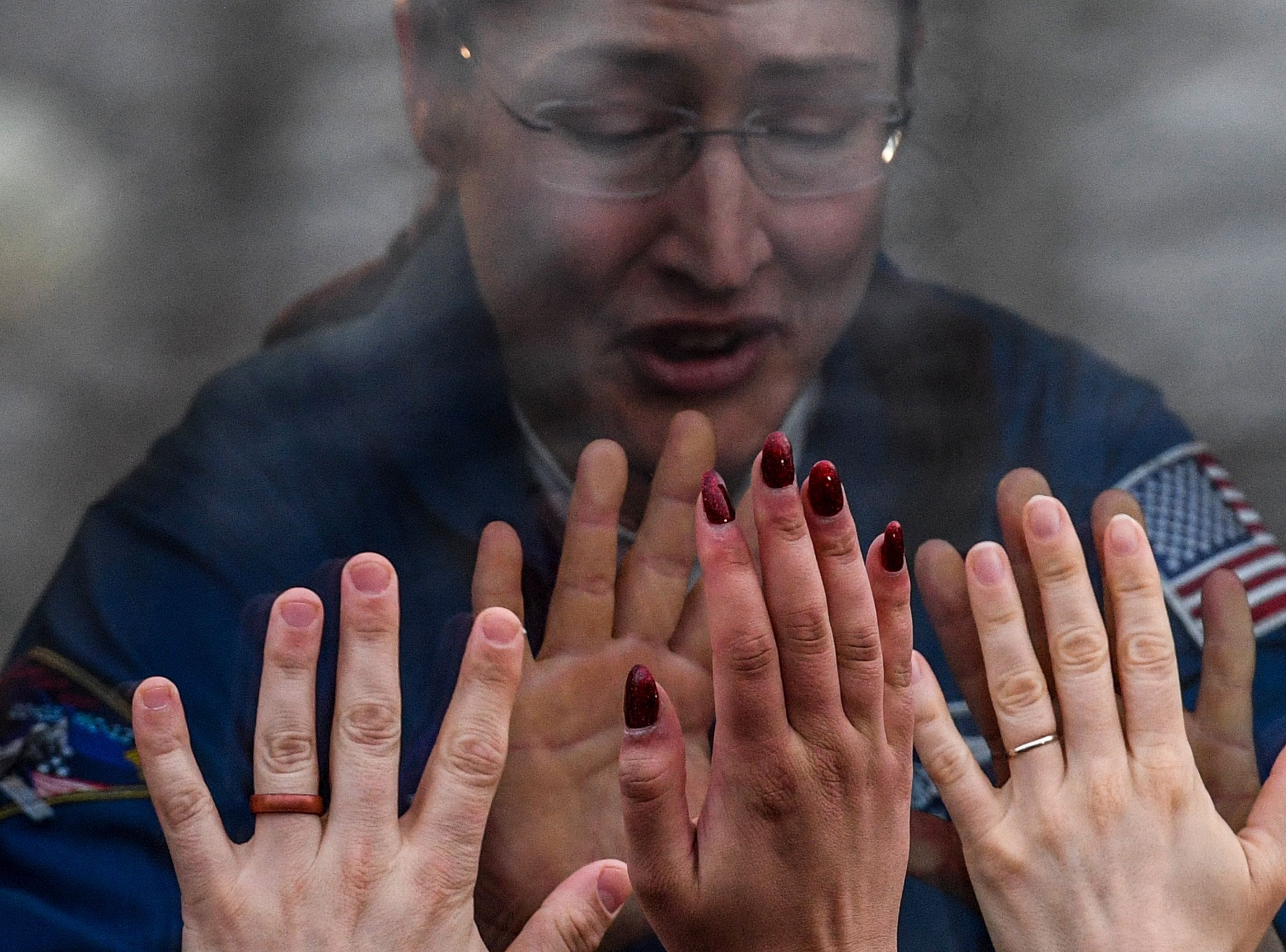 NASA astronaut Christina Hammock Koch, a member of the International Space Station expedition 59/60, gestures from inside a bus during a farewell ceremony outside the Cosmonaut hotel prior to the launch onboard the Soyuz MS-12 spacecraft from the Russian-leased Baikonur cosmodrome in Kazakhstan on March 14, 2019.