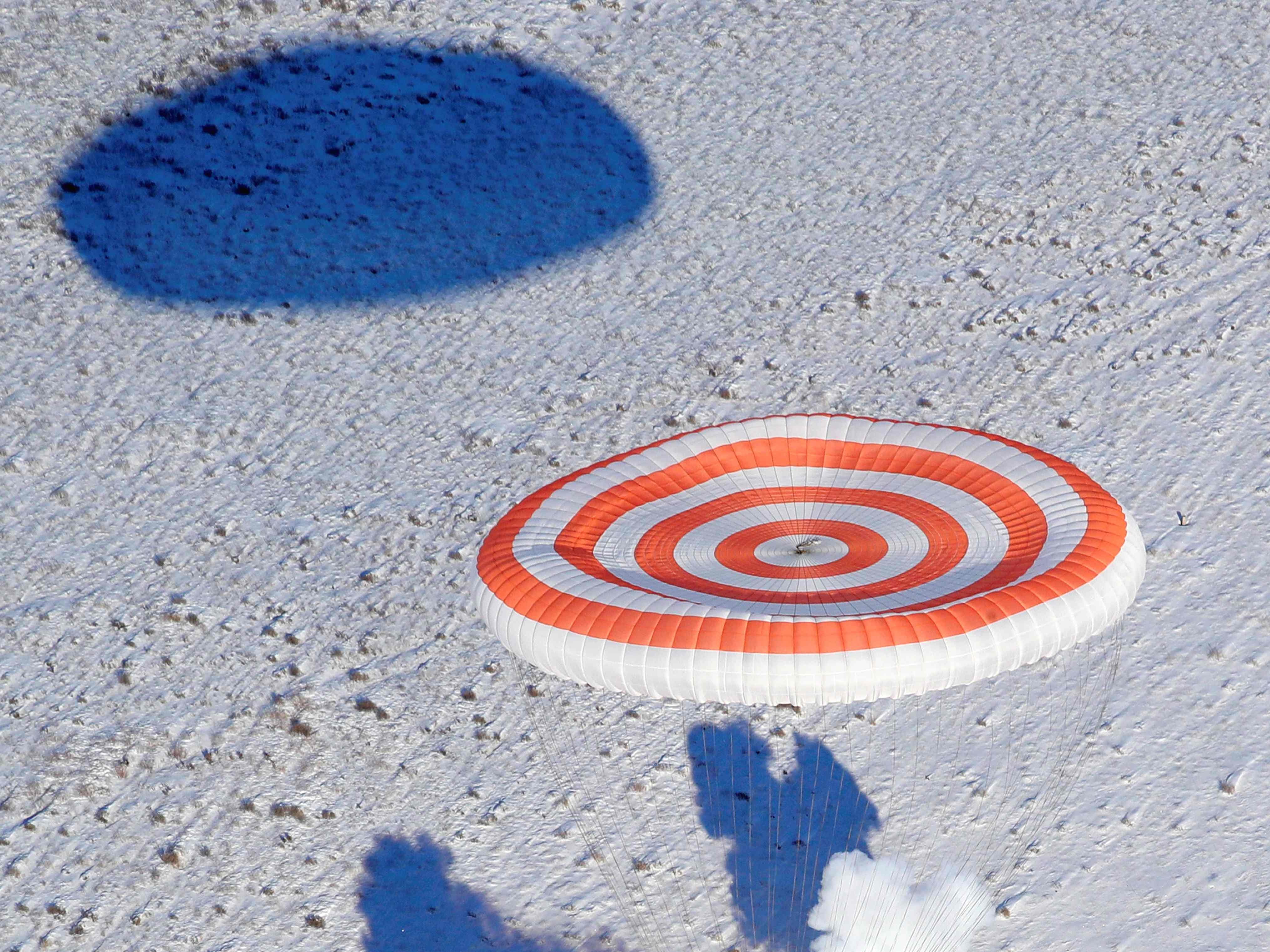 The Soyuz MS-05 space capsule carrying the International Space Station crew lands in a remote area outside the town of Dzhezkazgan, Kazakhstan, Dec. 14, 2017. 