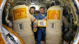 Russian cosmonauts Oleg Kononenko and Alexey Ovchinin honor Alexei Leonov when conducting a spacewalk the day before his 85th birthday.