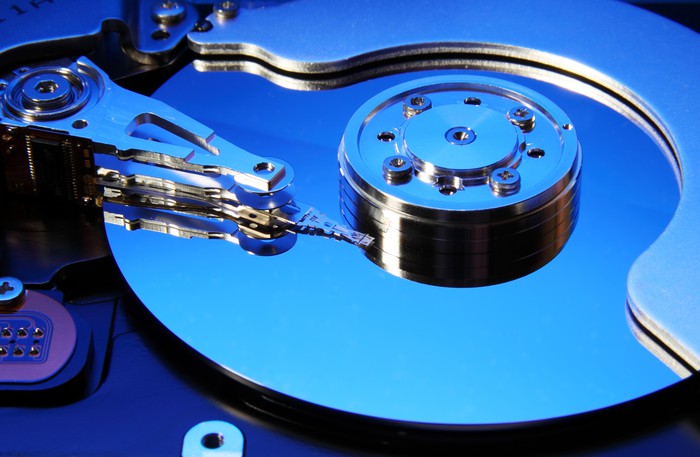 A closeup of a hard disk bathed in blue light. 