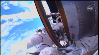 NASA astronaut Christina Koch can be seen here, with red striped on her spacesuit, during the spacewalk on Oct. 18, 2019.