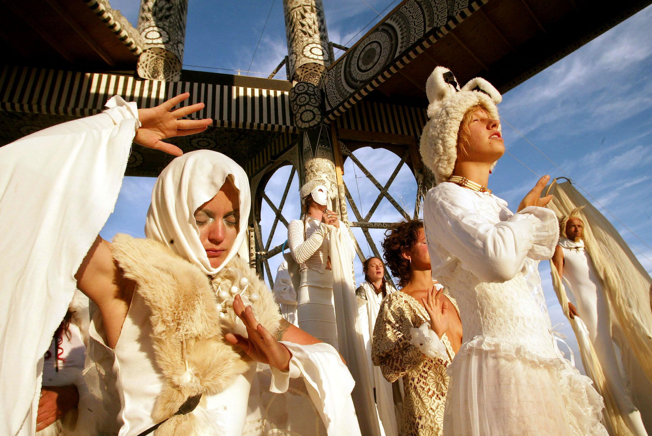 Members of the Naobi Village perform an early morning ritual at the Burning Man Festival in Black Ro..