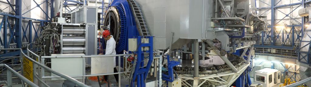 This view shows the VLT Unit Telescope 4 inside its enclosure. The telescope itself appears in the centre and the new MUSE instrument is on the left. This unique and powerful tool for discovery uses 24 spectrographs to separate light into its component colours to create both images and spectra of selected regions of the sky. MUSE couples the discovery potential of an imaging device with the measuring capabilities of a spectrograph, while taking advantage of the much better image sharpness provided by adaptive optics. Image Credit: Eric Le Roux/University Claude Bernard Lyon 1/CNRS/ESO 