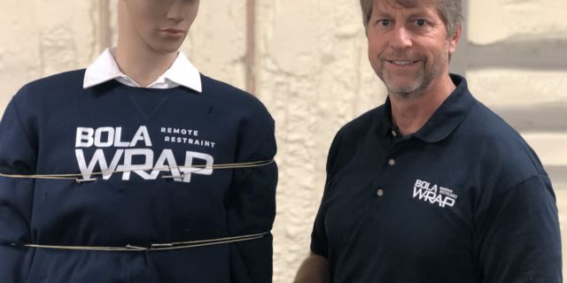 David Norris, Wrap Technologies CEO, demonstrates the BolaWrap on a mannequin.