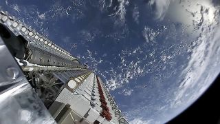 A view of SpaceX's first 60 Starlink satellites in orbit, still in stacked configuration, with the Earth as a brilliant blue backdrop on May 23, 2019.