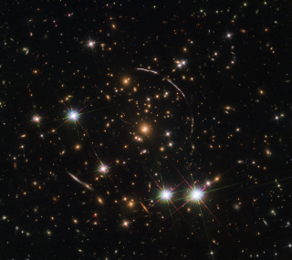 When the Hubble Space Telescope turned its gaze toward the remote galaxy known as the "Sunburst Arc," it saw not one but 12 separate images of the lone cosmic object. That's because there's a massive galaxy cluster in the foreground warping the light with its intense gravitational pull. This illusion is known as gravitational lensing, a phenomenon that Albert Einstein first described in his theory of general relativity. "This 'funhouse mirror' effect not only stretches the background galaxy image, but also creates multiple images of the same galaxy," NASA officials said in a statement.