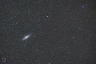 Two meteors dart across the sky near the Andromeda galaxy, the Milky Way's closest galactic neighbor, in this starry image captured by astrophotographer Omid Qadrdan during the peak of the Perseid meteor shower. Andromeda's tiny satellite galaxy Messier 110 is also visible in this photo, appearing as a fuzzy "star" above and to the left of the galaxy's bright core. 