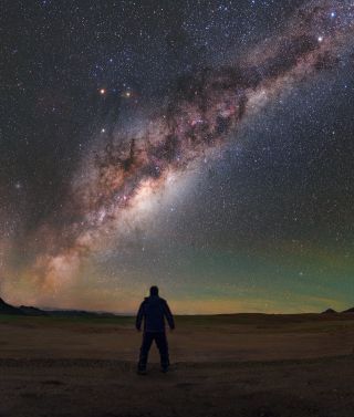 A skywatcher gazes up at the Milky Way galaxy's dusty core in this glittering photo taken from the Chajnantor plateau in Chile's Atacama Desert. This plateau is one of the highest and driest places on Earth, which makes it a great location for stargazing. For that reason, it was chosen to be the home of the European Southern Observatory's Atacama Large Millimeter/submillimeter Array (ALMA). 