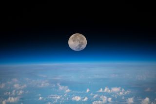 The full moon of June, also known as the Strawberry Moon, looms above Earth's horizon in this photo taken by an astronaut at the International Space Station. The image was captured on June 17 as the space station was orbiting 254 miles (409 kilometers) above the Pacific Ocean northeast of Guam. 