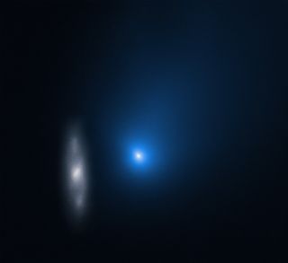 The interstellar comet Borisov appears to come face-to-face with a distant spiral galaxy in this image from the Hubble Space Telescope. Hubble captured this image on Dec. 12, as the interstellar comet was racing through the inner solar system. At the time, the object was about 260 million miles (420 million kilometers) from Earth, while the unnamed background galaxy (officially designated 2MASX J10500165-0152029), is nearly half a billion light-years away. The galaxy appears smudged because Hubble was tracking the motion of the comet, which was zooming through space at a speed of about 109,000 mph (175,000 km/h). 