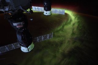 Lime-green auroras shimmy over the South Pole in this view from the International Space Station. "Years ago at the South Pole, I looked up to the aurora for inspiration through the 6-month winter night," NASA astronaut Christina Koch tweeted from space. "Now I know they’re just as awe inspiring from above."&nbsp;In the foreground of the image, two Russian spacecraft are docked to the orbiting lab: the Soyuz MS-12 crew spacecraft and the Progress 72 cargo vessel.