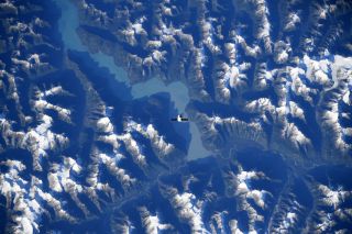 Astronaut Christina Koch snapped this image of the SpaceX Dragon flying over the Canadian mountains. 