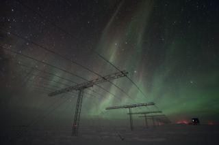 Wispy, green auroras shimmer over Antarctica in this photo captured from the Amundsen-Scott South Pole Station, a research site operated by the National Science Foundation. 