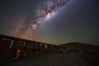 The colorful core of the Milky Way sparkles above the European Southern Observatory's Residencia, a building featured in the James Bond film "Quantum of Solace" that was destroyed in a dramatic explosion (with the help of computer graphics, not real explosives). Residencia houses astronomers and other visitors at the Paranal Observatory in Chile, which is home to the Very Large Telescope Array and several other telescope facilities. 