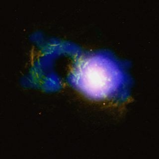 A raging storm, triggered by a powerful quasar, is brewing at the center of a teacup-shaped cosmic structure that lies in a distant galaxy known as SDSS 1430+1339.