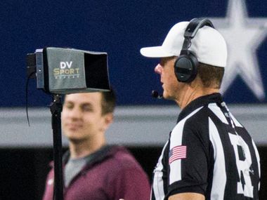 Referee Bill Tilley watches the instant replay screen on the sideline after a fumble turnover during the fourth quarter of the UIL 4A Division I state championship game between Waco La Vega and Liberty Hill on Friday, December 21, 2018 at AT&T Stadium in Arlington. (Ashley Landis/The Dallas Morning News)