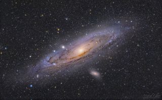 The arms and core of the Andromeda Galaxy glow among a sea of multicolored stars in this deep-space photo captured from the Cumeada Observatory at the Dark Sky Alqueva Reserve in Reguengos de Monsaraz, Portugal. 