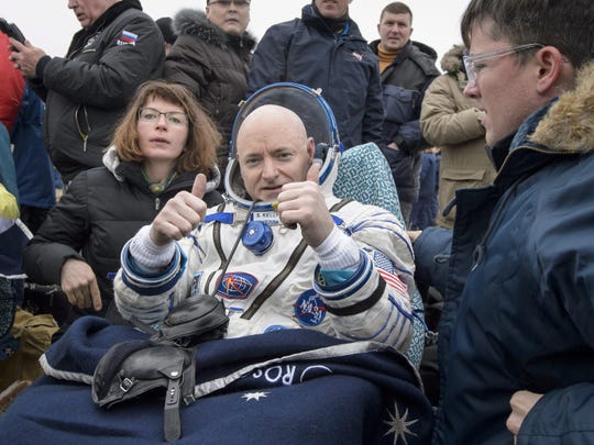 Scott Kelly of NASA rests in a chair outside of the Soyuz TMA-18M spacecraft in Kazakhstan after spending almost a year in space.