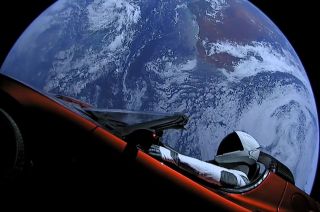 SpaceX's Starman mannequin sits inside Elon Musk's red Tesla Roadster with Earth in the background, shortly after the initial launch of SpaceX’s Falcon Heavy rocket on Feb. 6, 2018. 