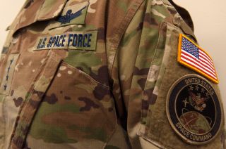 Traditional camouflage uniform adorned with a blue "U.S. Space Force" nameplate.