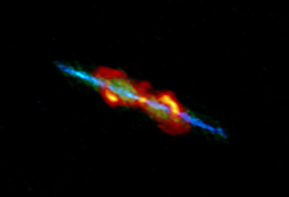 ALMA image of the W43A system; the high-velocity bipolar jets ejected from the central aged star are seen in blue, low velocity outflow is shown in green, and dusty clouds entrained by the jets are shown in orange. Image credit: ALMA / ESO / NAOJ / NRAO / Tafoya et al.