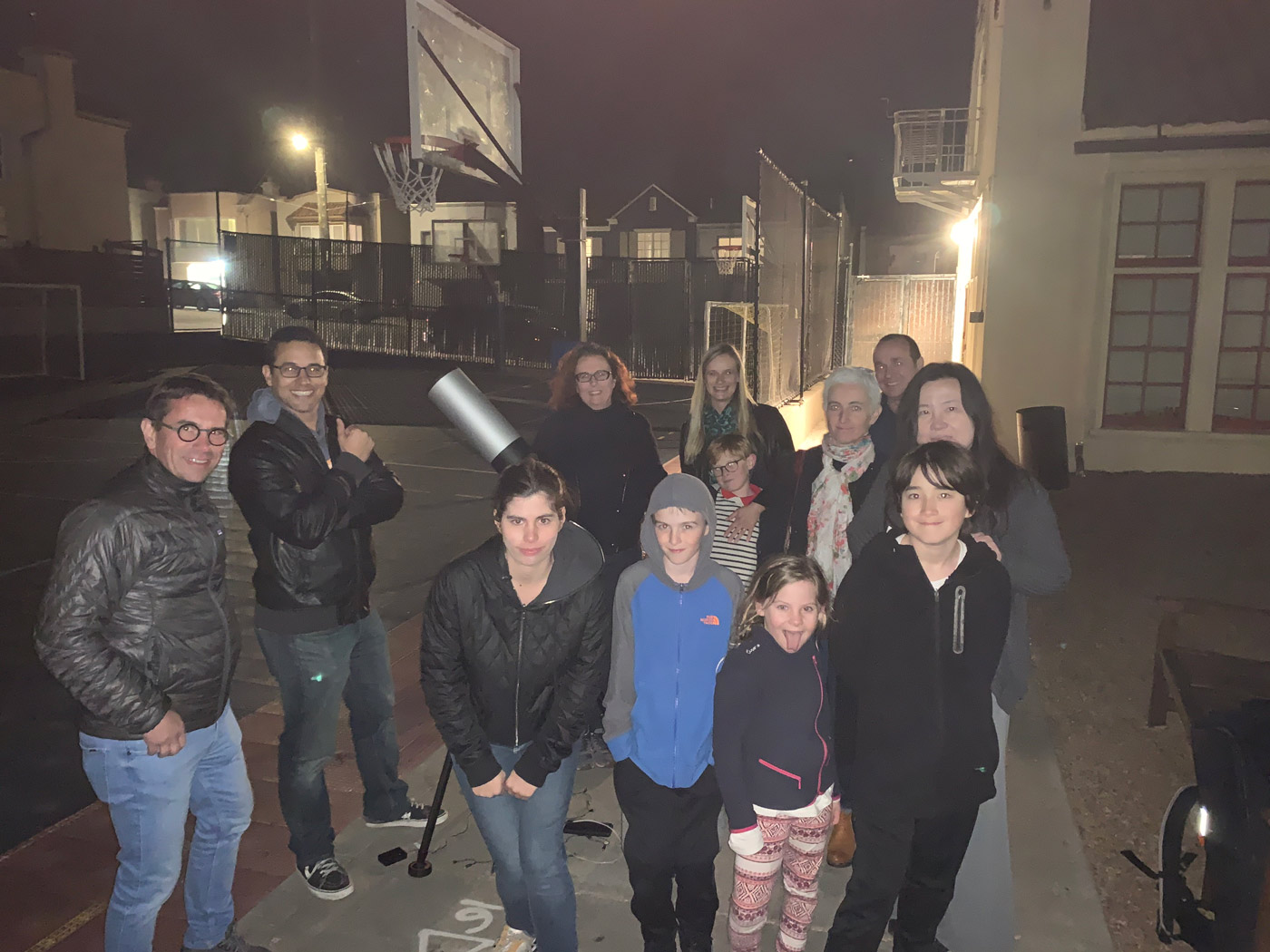 a group posing with the eVscope at a viewing