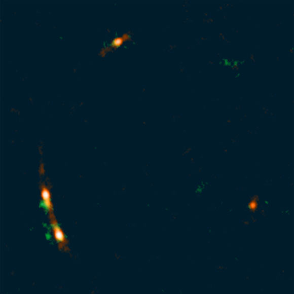 This ALMA image shows the quadruply lensed quasar MG J0414+0534; emissions from dust and ionized gas shown in red and emissions from carbon monoxide gas shown in green. Image credit: ALMA / ESO / NAOJ / NRAO / Inoue et al.