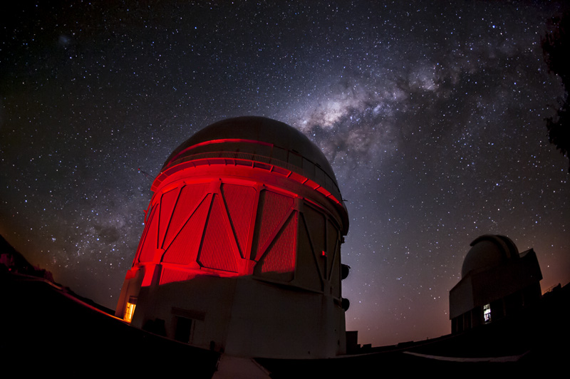 Telescope dome with starry night sky in background.