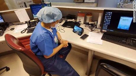 A health care provider at North Shore University Hospital uses an Echo Show to communicate with a coroanvirus patient. 