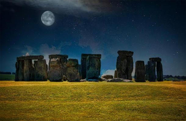 Stonehenge at night with stars and the Moon in the sky. (Michelle / Adobe stock)