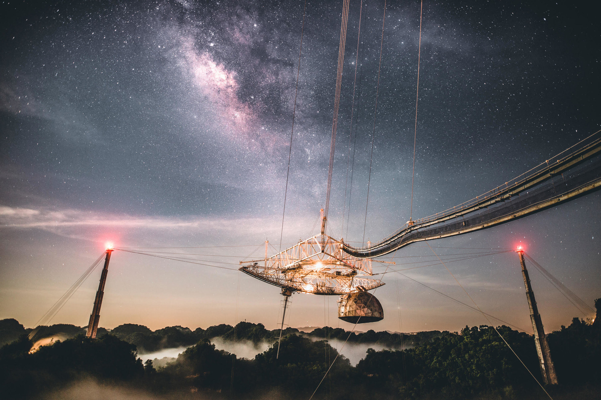 Photo of the Arecibo Observatory in Puerto Rico, with a starry night sky as background