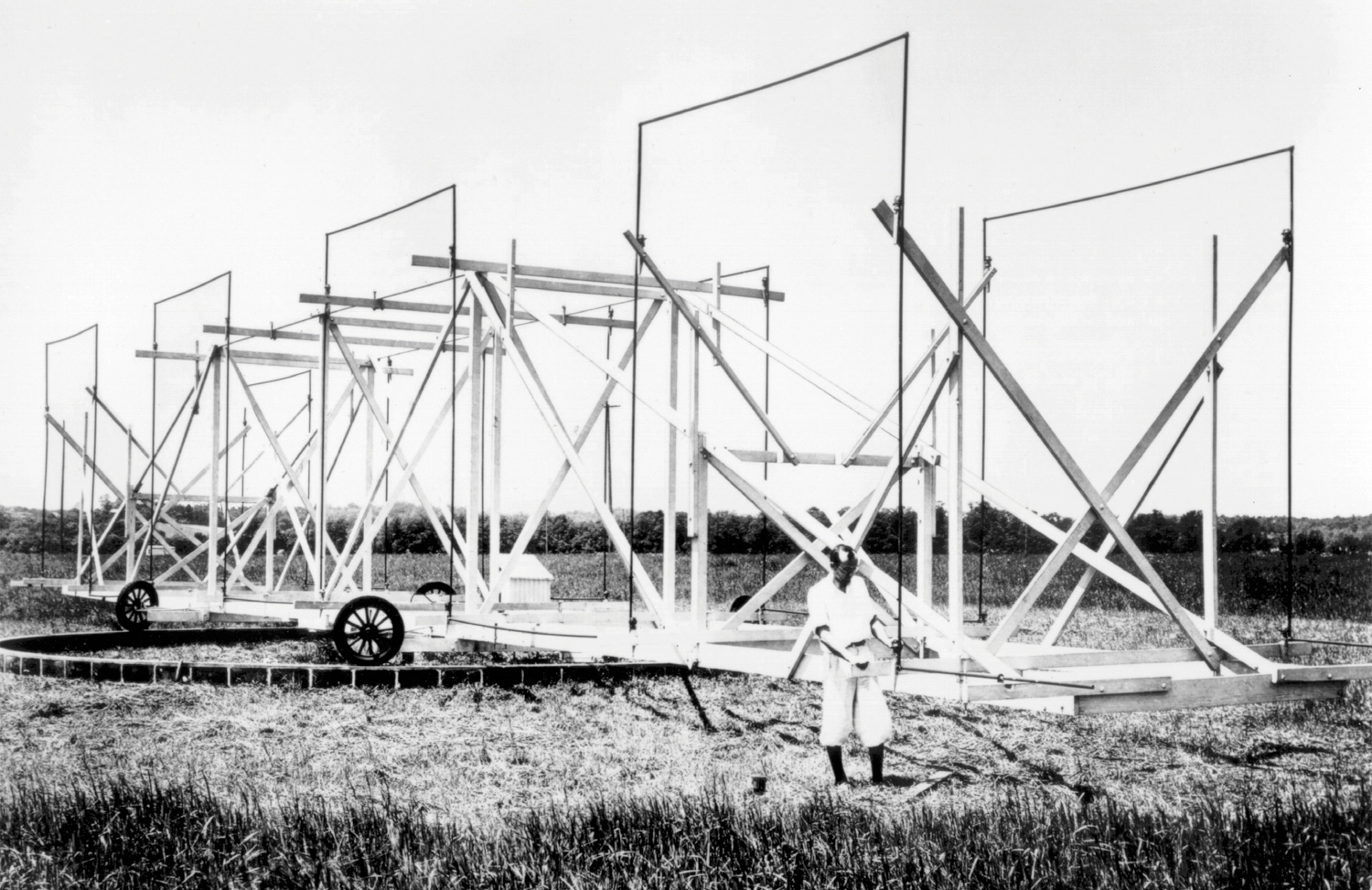 Black and white photo of Karl Janksy in a field in front of the device nicknamed “Jansky’s merry-go-round”