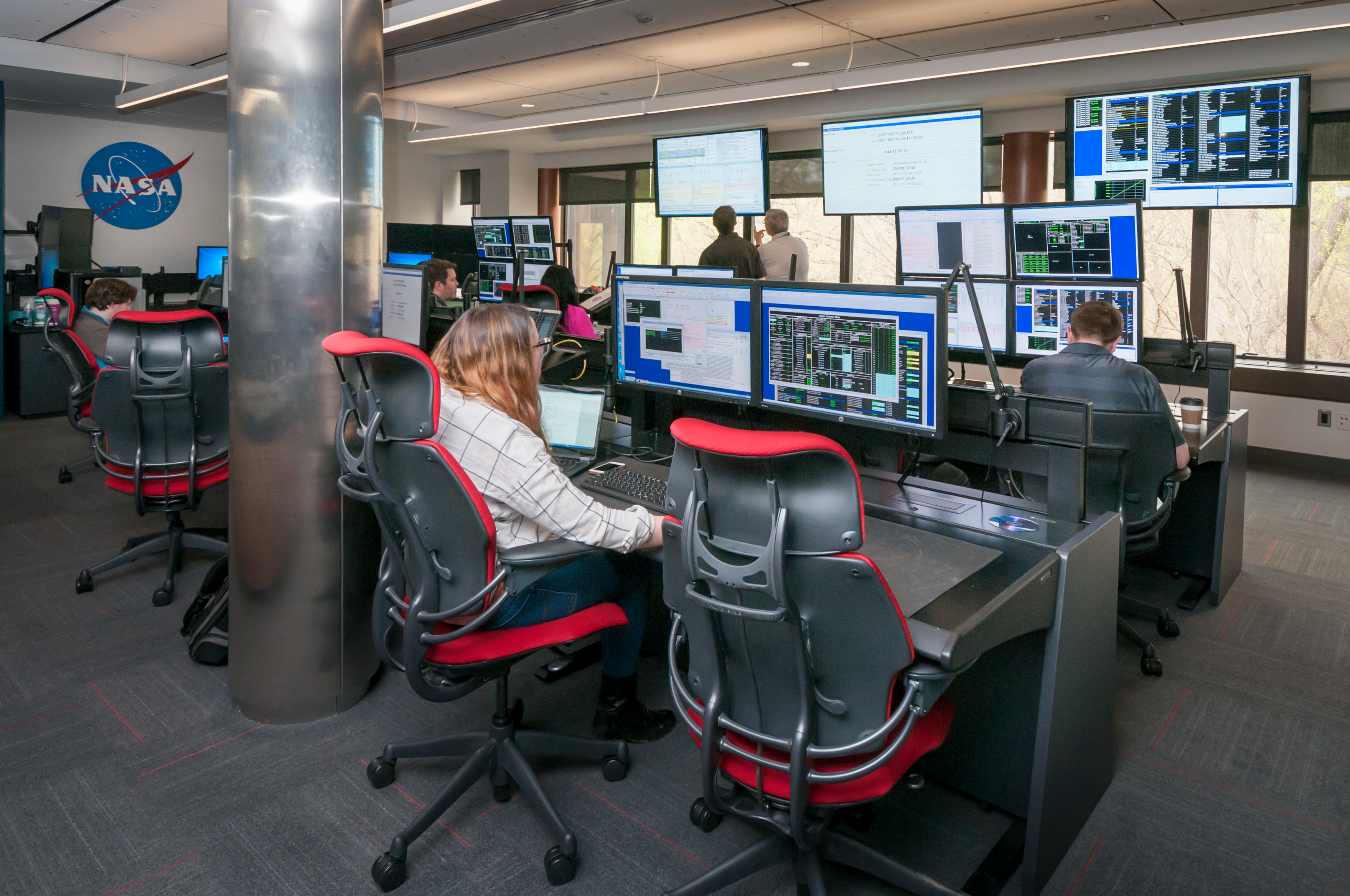 People sitting at desks using computers.