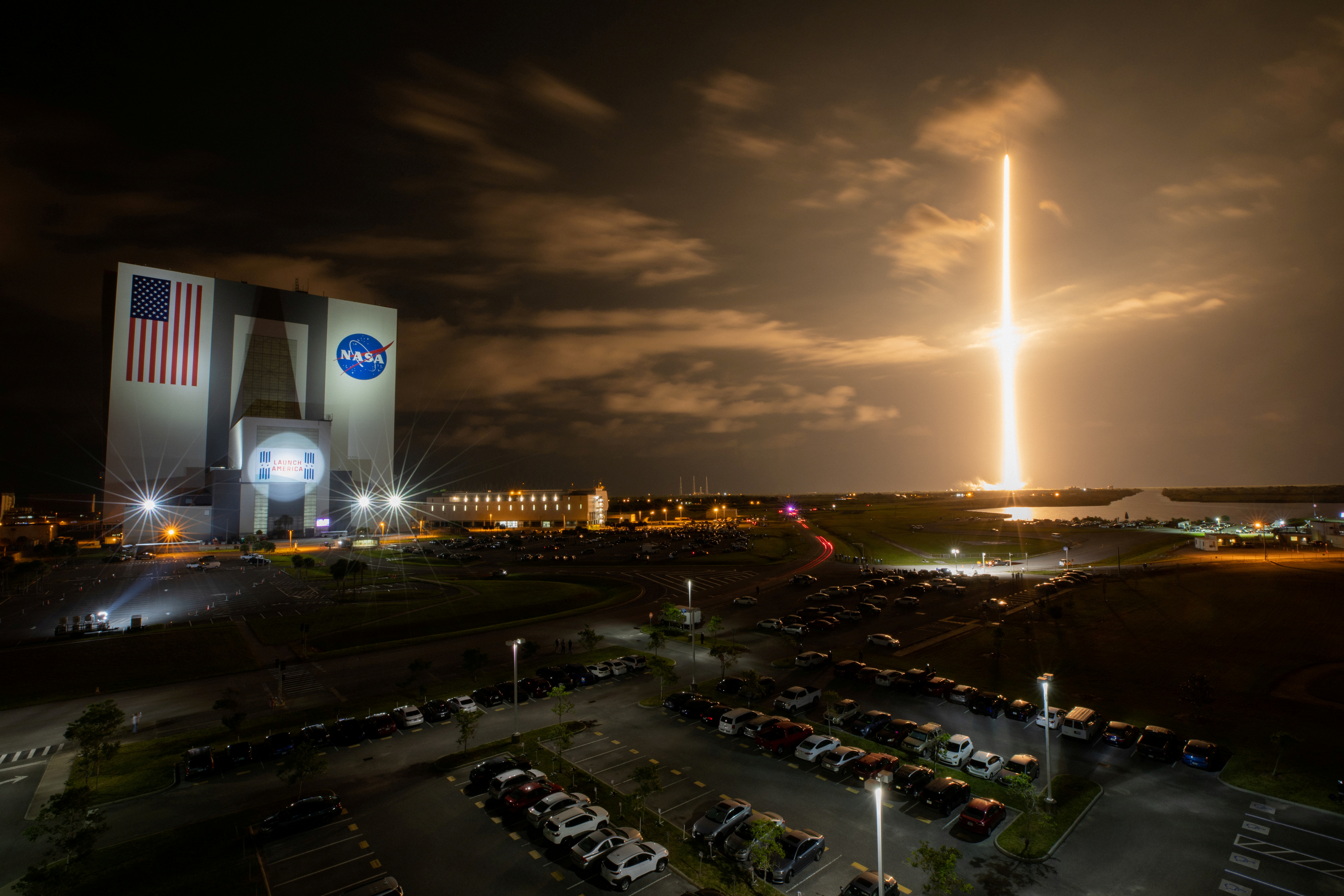 With a view of the iconic Vehicle Assembly Building at left, a SpaceX Falcon 9 rocket soars upward from Launch Complex 39A carrying the company’s Crew Dragon Endeavour capsule and four Crew-2 astronauts towards the International Space Station at NASA’s Kennedy Space Center in Cape Canaveral, Florida, U.S. April 23, 2021. NASA/Ben Smegelsky/Handout via REUTERS