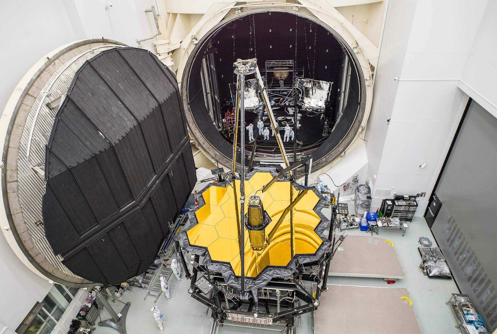 The telescope’s hexagonal mirror is shown on its way out of a huge vault.