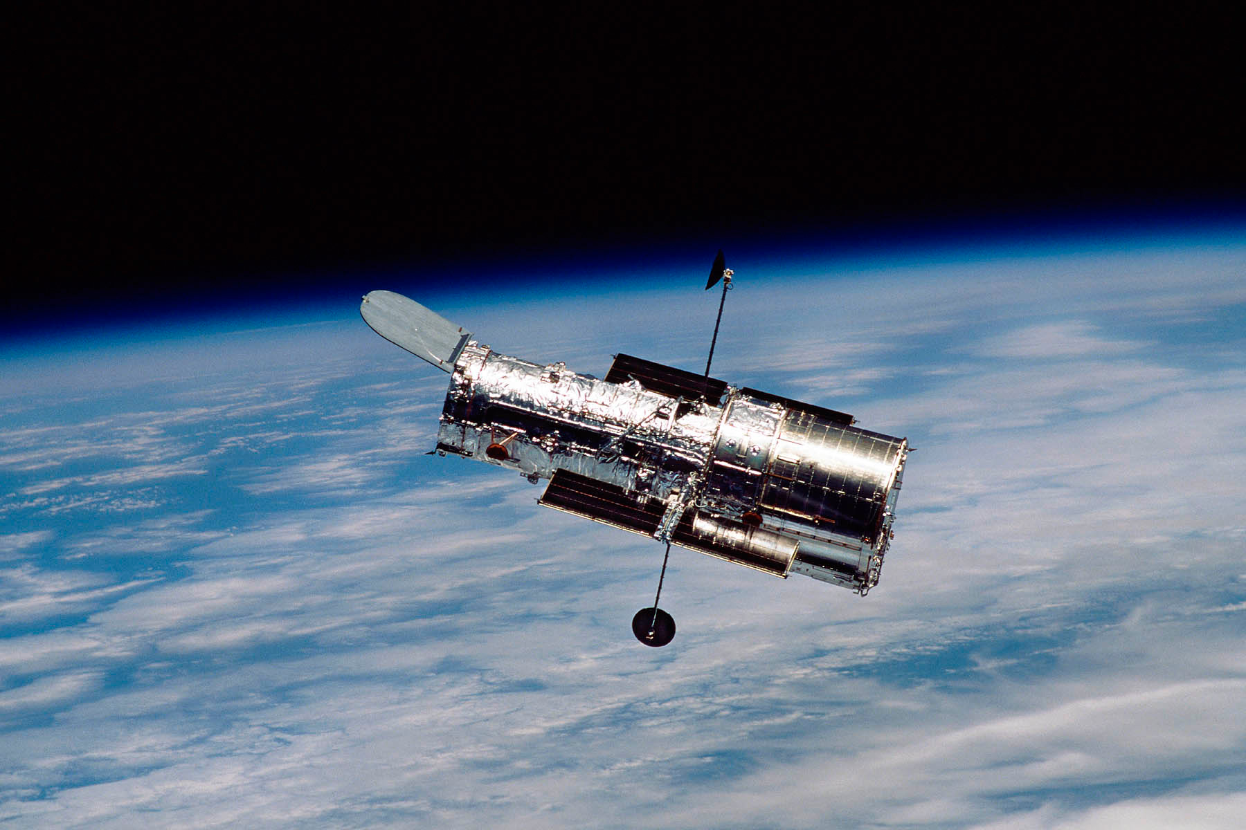 Hubble Space Telescope floating above earth.