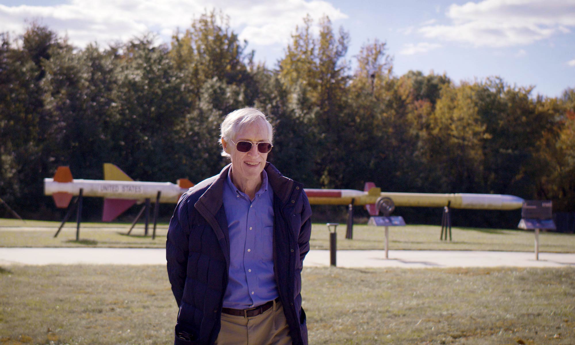 Man with grey hair and a blue shirt.