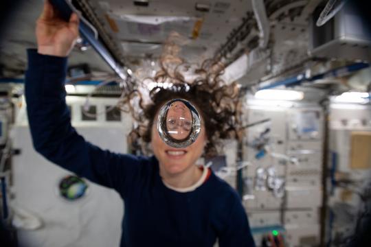 NASA astronaut Christina Koch playfully demonstrates how fluids behave in the weightless environment of microgravity aboard the International Space Station. (Credit: NASA) 