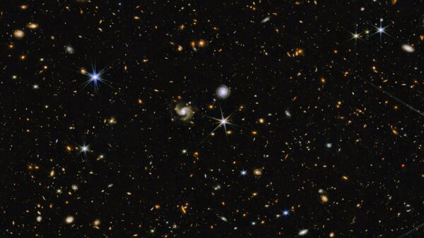 Hundreds of galaxies appear in this image, which combines near-infrared colors captured by Webb's telescope with those from Hubble.